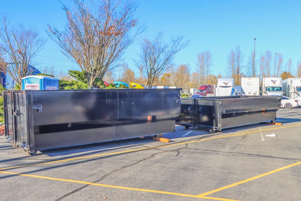 Professional dumpster rental service with roll-off container on residential driveway in Middletown